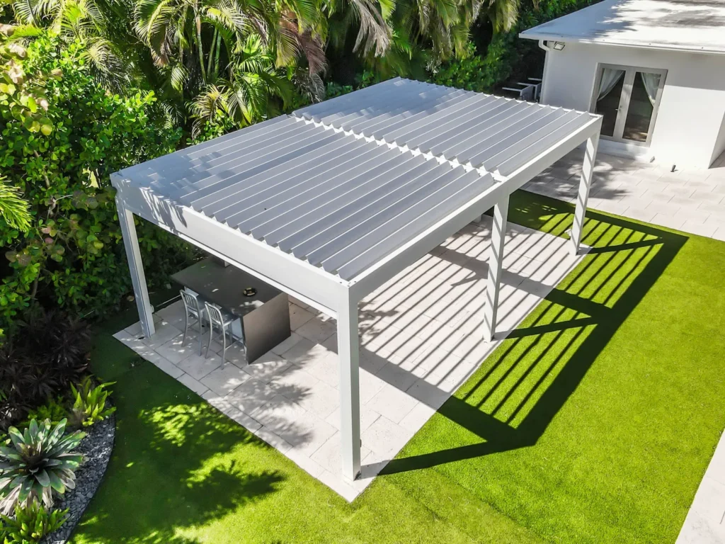 Louvered pergola installation over outdoor kitchen